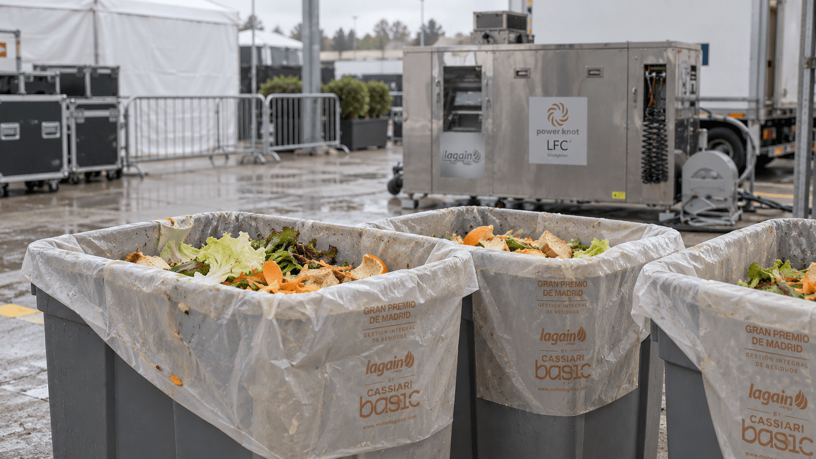 Bins of organic waste with compostable bags next to an LFC biodigester at MADRING